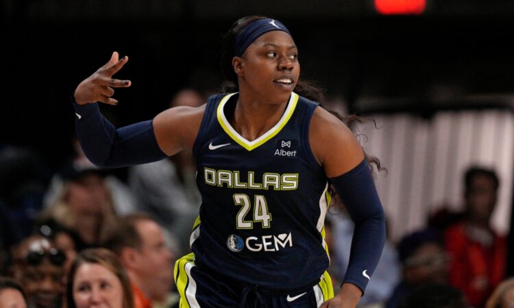 Arike Ogunbowale celebrates after making a three-pointer for the Dallas Wings.
