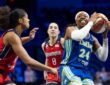 Arike Ogunbowale driving hard past a perimeter defender with her right hand during a regular-season WNBA game.
