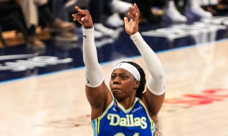 Arike Ogunbowale of the Dallas Wings rising for a jump shot during the 2026 home opener against the Atlanta Dream.