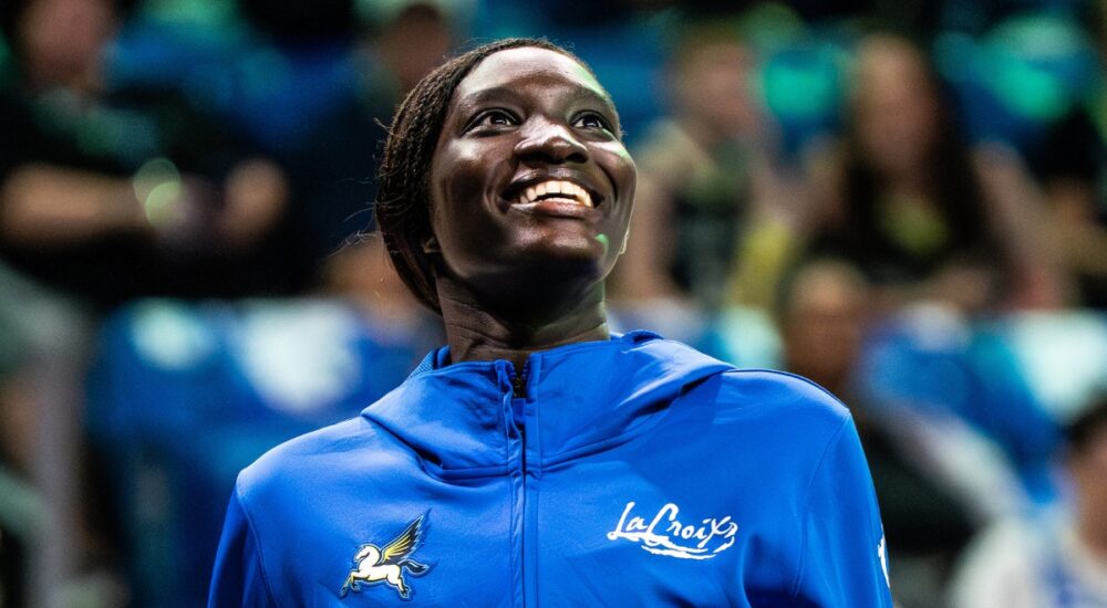 Forward Awak Kuier wearing a blue Dallas Wings warmup shirt while looking focused on the floor before a game.