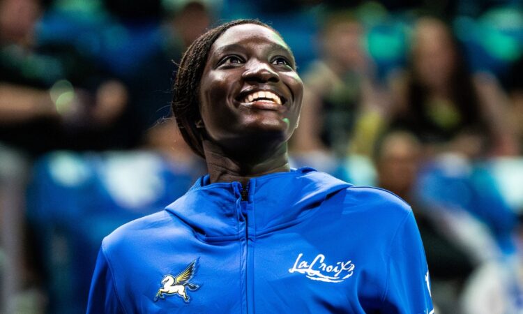 Forward Awak Kuier wearing a blue Dallas Wings warmup shirt while looking focused on the floor before a game.