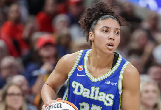 Azzi Fudd (35) of the Dallas Wings looks to make a play during her WNBA regular-season debut against the Indiana Fever.