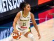Azzi Fudd of the Dallas Wings attacking down the lane on a dribble drive against Natasha Howard of the Minnesota Lynx.