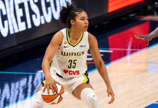 Azzi Fudd of the Dallas Wings attacking down the lane on a dribble drive against Natasha Howard of the Minnesota Lynx.