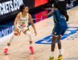 Rookie guard Azzi Fudd of the Dallas Wings handling the ball while being defended by Natasha Howard of the Minnesota Lynx.