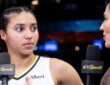 Rookie guard Azzi Fudd standing on the court at Barclays Center holding a microphone during a postgame interview.