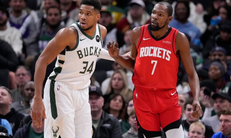 Giannis Antetokounmpo #34 of the Milwaukee Bucks defends Kevin Durant #7 of the Houston Rockets during a game at Fiserv Forum.
