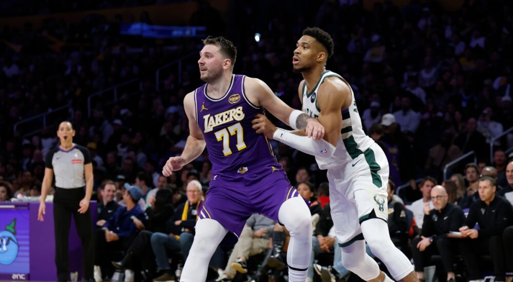 Giannis Antetokounmpo #34 of the Milwaukee Bucks and Luka Doncic #77 of the Los Angeles Lakers battle for position at Crypto.com Arena.