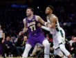 Giannis Antetokounmpo #34 of the Milwaukee Bucks and Luka Doncic #77 of the Los Angeles Lakers battle for position at Crypto.com Arena.