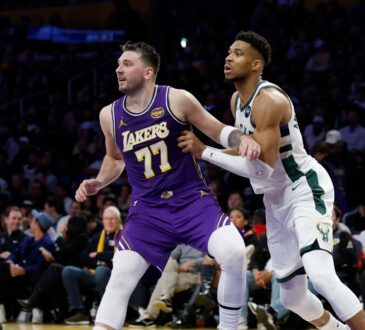 Giannis Antetokounmpo #34 of the Milwaukee Bucks and Luka Doncic #77 of the Los Angeles Lakers battle for position at Crypto.com Arena.