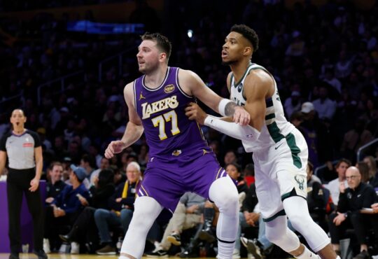 Giannis Antetokounmpo #34 of the Milwaukee Bucks and Luka Doncic #77 of the Los Angeles Lakers battle for position at Crypto.com Arena.