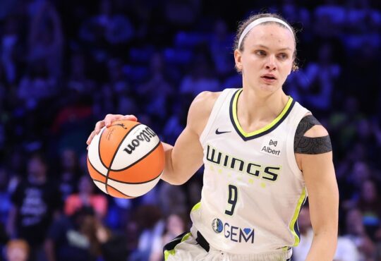 Grace Berger of the Dallas Wings handles the ball during a WNBA game against the Phoenix Mercury at College Park Center.