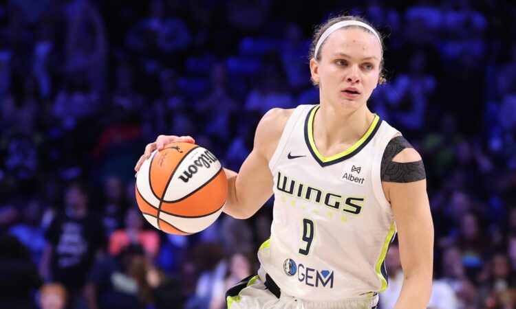 Grace Berger of the Dallas Wings handles the ball during a WNBA game against the Phoenix Mercury at College Park Center.