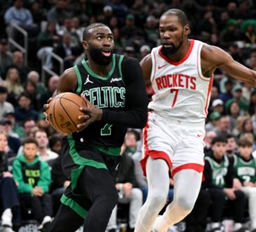 Jaylen Brown #7 of the Boston Celtics drives to the basket against Kevin Durant #7 of the Houston Rockets at TD Garden.