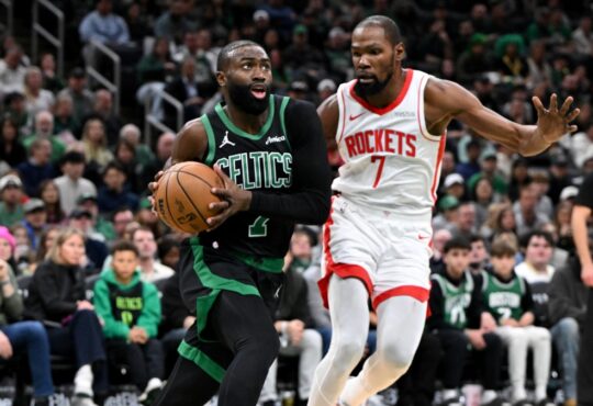 Jaylen Brown #7 of the Boston Celtics drives to the basket against Kevin Durant #7 of the Houston Rockets at TD Garden.