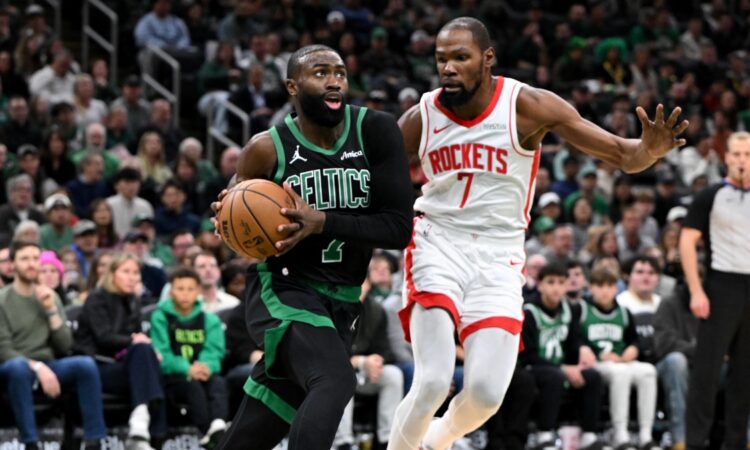 Jaylen Brown #7 of the Boston Celtics drives to the basket against Kevin Durant #7 of the Houston Rockets at TD Garden.