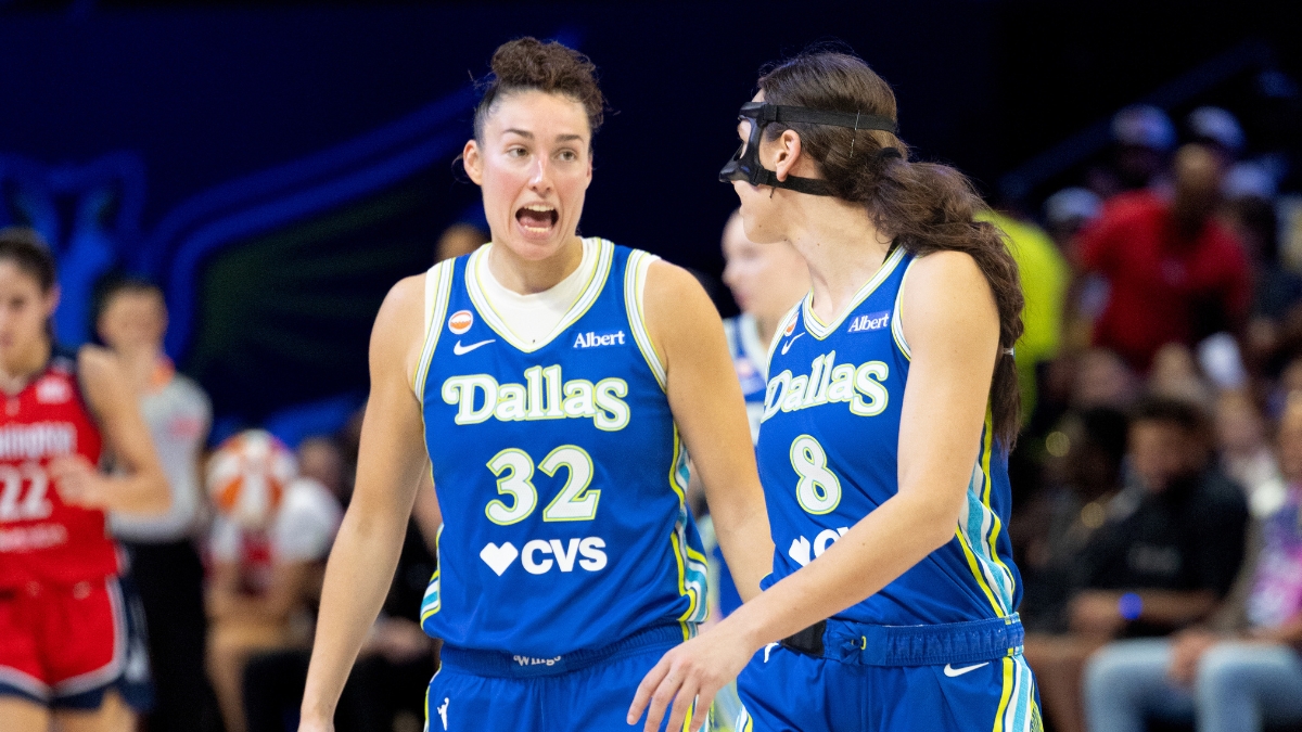 Jessica Shepard and Alanna Smith standing close together on the hardwood, talking and gesturing during a stoppage in play against the Washington Mystics.