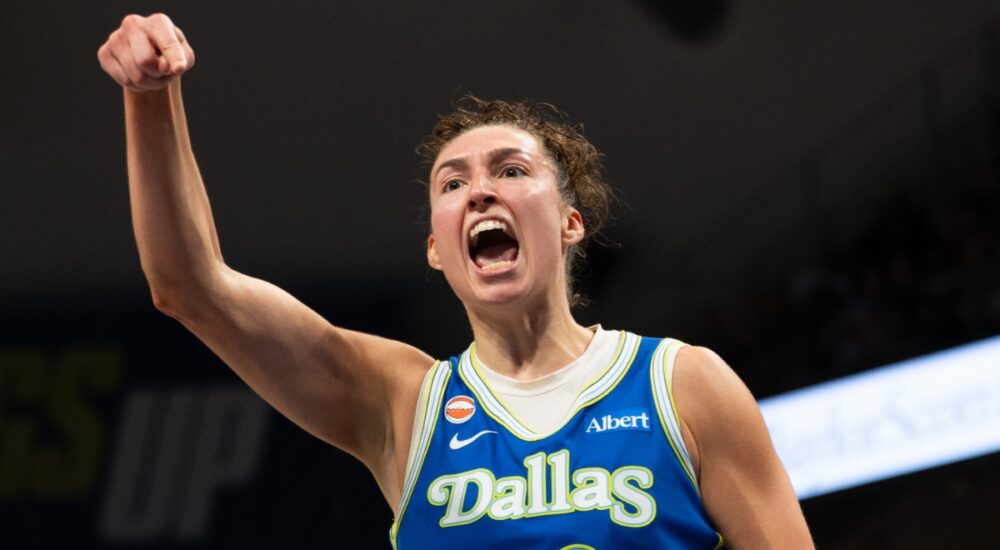 Dallas Wings forward Jessica Shepard flexing and celebrating on court during a game against the Las Vegas Aces at College Park Center.
