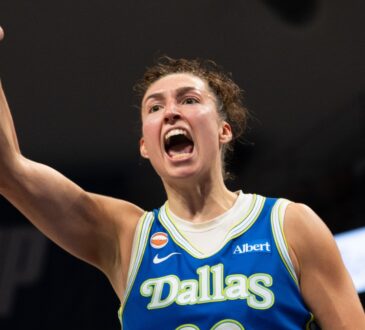 Dallas Wings forward Jessica Shepard flexing and celebrating on court during a game against the Las Vegas Aces at College Park Center.
