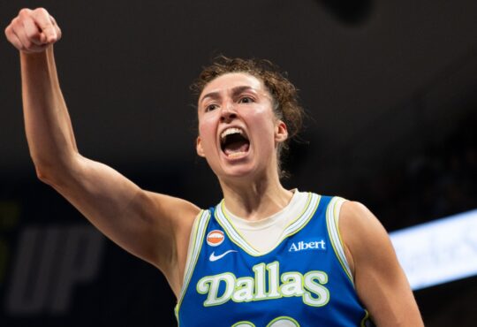 Dallas Wings forward Jessica Shepard flexing and celebrating on court during a game against the Las Vegas Aces at College Park Center.