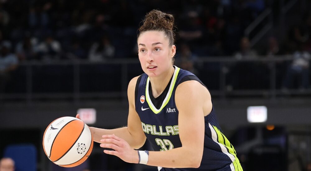 Jessica Shepard dribbling the basketball at the top of the key while reading the defense against the Chicago Sky.