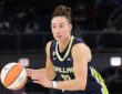 Jessica Shepard dribbling the basketball at the top of the key while reading the defense against the Chicago Sky.