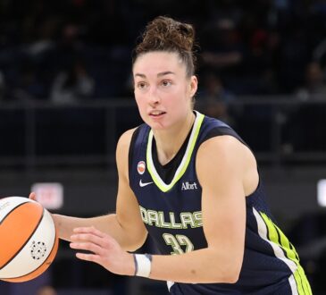 Jessica Shepard dribbling the basketball at the top of the key while reading the defense against the Chicago Sky.
