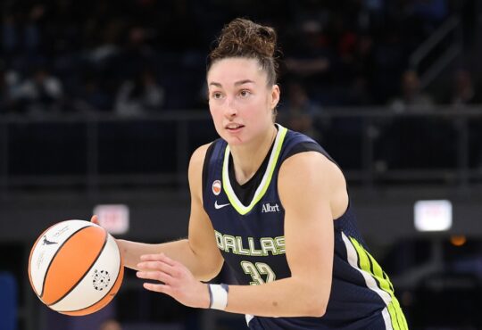 Jessica Shepard dribbling the basketball at the top of the key while reading the defense against the Chicago Sky.