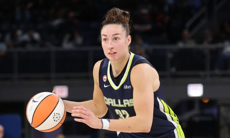 Jessica Shepard dribbling the basketball at the top of the key while reading the defense against the Chicago Sky.