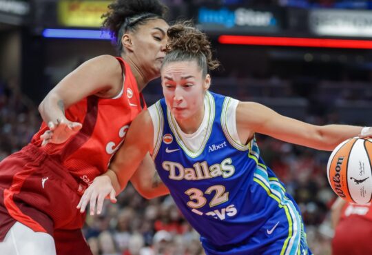 Jessica Shepard (32) of the Dallas Wings drives to the basket against Damiris Dantas (12) of the Indiana Fever.