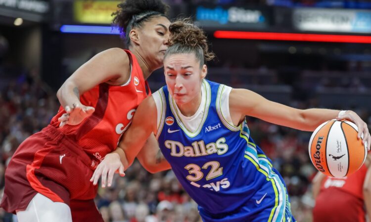 Jessica Shepard (32) of the Dallas Wings drives to the basket against Damiris Dantas (12) of the Indiana Fever.