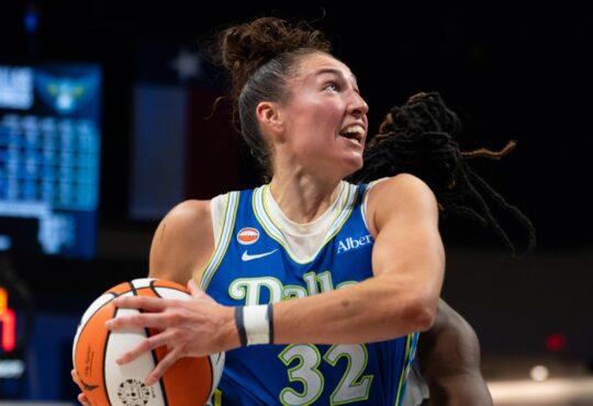 Center Jessica Shepard lowering her shoulder to drive hard down the lane, exploding past her defender toward the rim.