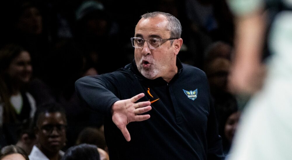 Head coach Jose Fernandez shouting instructions and gesturing toward his players from the sideline at Barclays Center.