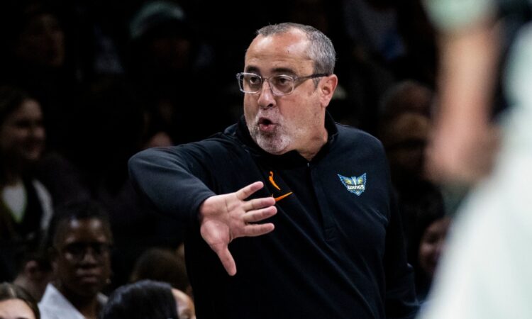 Head coach Jose Fernandez shouting instructions and gesturing toward his players from the sideline at Barclays Center.