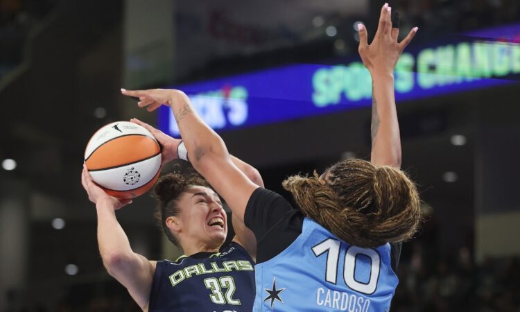 Chicago center Kamilla Cardoso extending her arm to block a low-post shot attempt by Dallas forward Jessica Shepard during the first half.