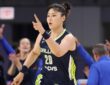 Li Yueru smiling and clapping in celebration on the court during the second half against the Chicago Sky.