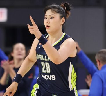 Li Yueru smiling and clapping in celebration on the court during the second half against the Chicago Sky.