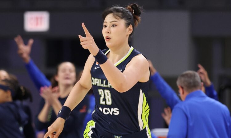 Li Yueru smiling and clapping in celebration on the court during the second half against the Chicago Sky.