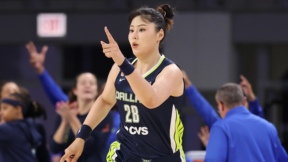 Li Yueru smiling and clapping in celebration on the court during the second half against the Chicago Sky.