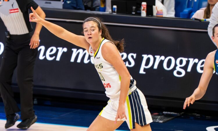 Maddy Siegrist of the Dallas Wings rising for a mid-range jump shot over Napheesa Collier of the Minnesota Lynx.