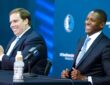 Mavericks President Masai Ujiri and Governor Patrick Dumont posing side-by-side at the podium during the introductory press conference.