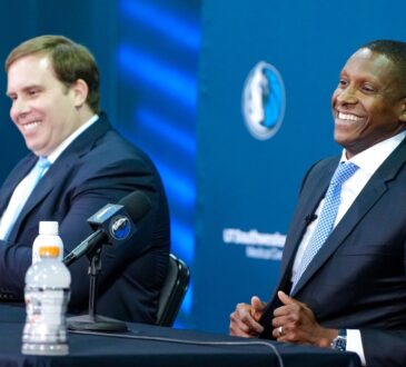 Mavericks President Masai Ujiri and Governor Patrick Dumont posing side-by-side at the podium during the introductory press conference.