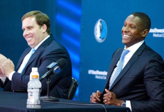 Mavericks President Masai Ujiri and Governor Patrick Dumont posing side-by-side at the podium during the introductory press conference.