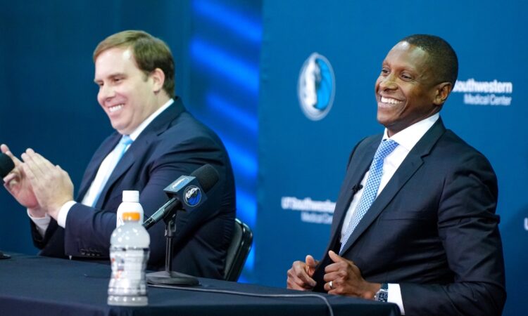 Mavericks President Masai Ujiri and Governor Patrick Dumont posing side-by-side at the podium during the introductory press conference.
