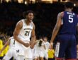 Michigan sophomore big man Morez Johnson Jr. screaming in celebration amidst falling confetti on the court after winning the national title.