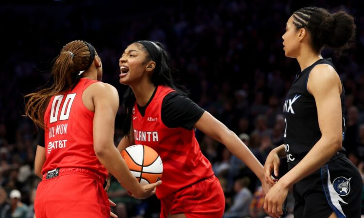 Naz Hillmon (00) of the Atlanta Dream celebrates with Angel Reese (5) during the fourth quarter against the Minnesota Lynx at Target Center.