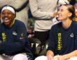 Paige Bueckers and Arike Ogunbowale sitting together on the Dallas Wings bench during the game against the Minnesota Lynx.