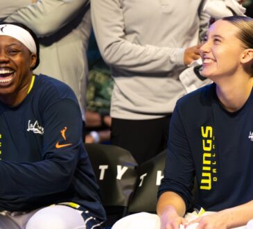 Paige Bueckers and Arike Ogunbowale sitting together on the Dallas Wings bench during the game against the Minnesota Lynx.