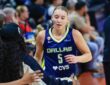 Paige Bueckers (5) and Arike Ogunbowale (24) of the Dallas Wings exchange a high five.