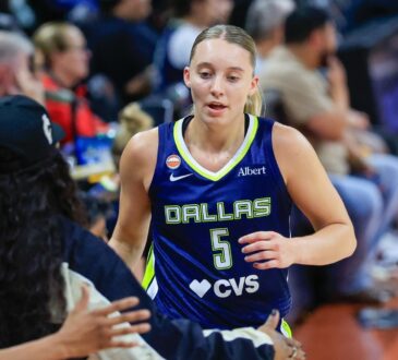 Paige Bueckers (5) and Arike Ogunbowale (24) of the Dallas Wings exchange a high five.